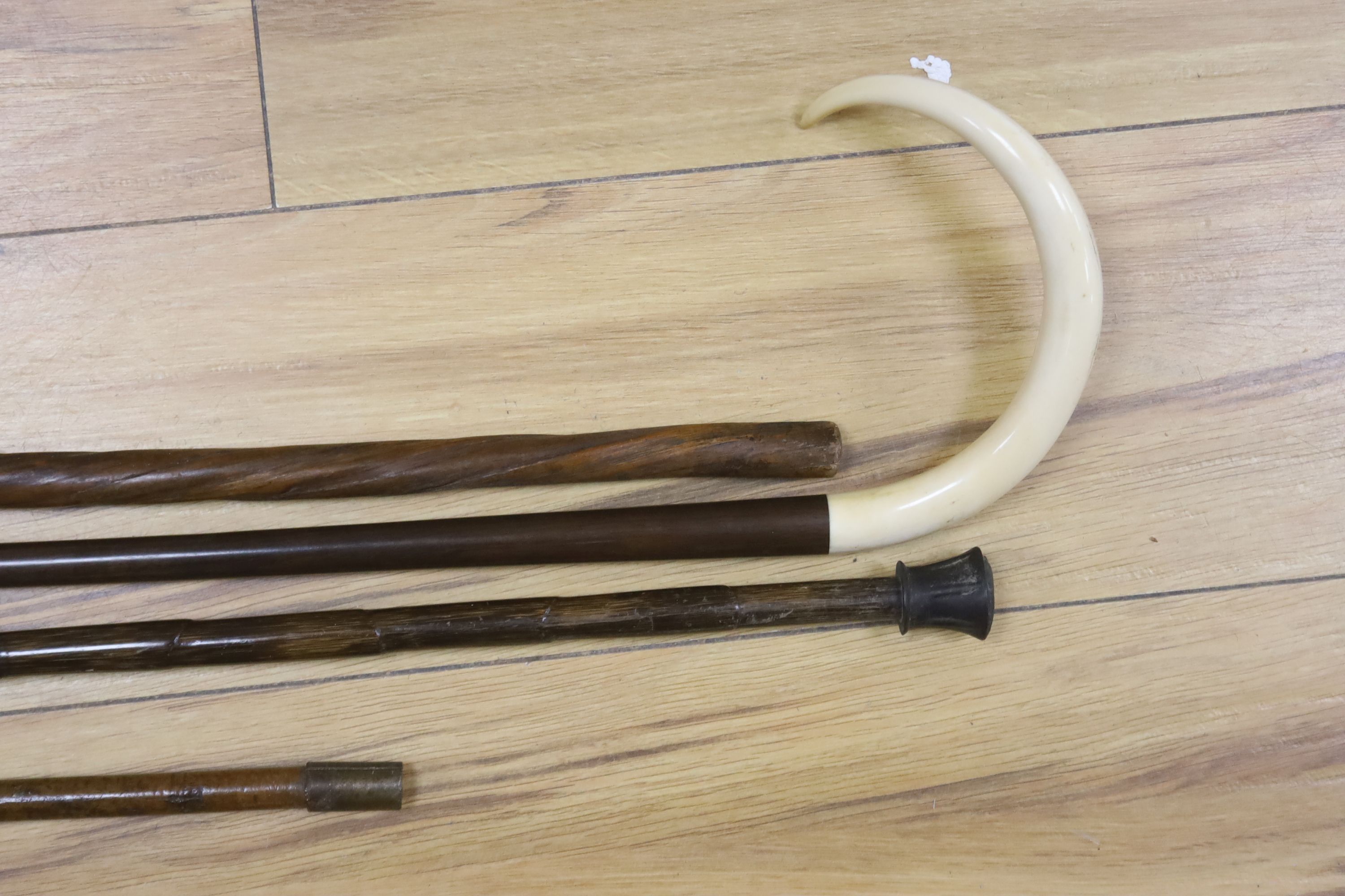 Four walking sticks, one horn and silver mounted